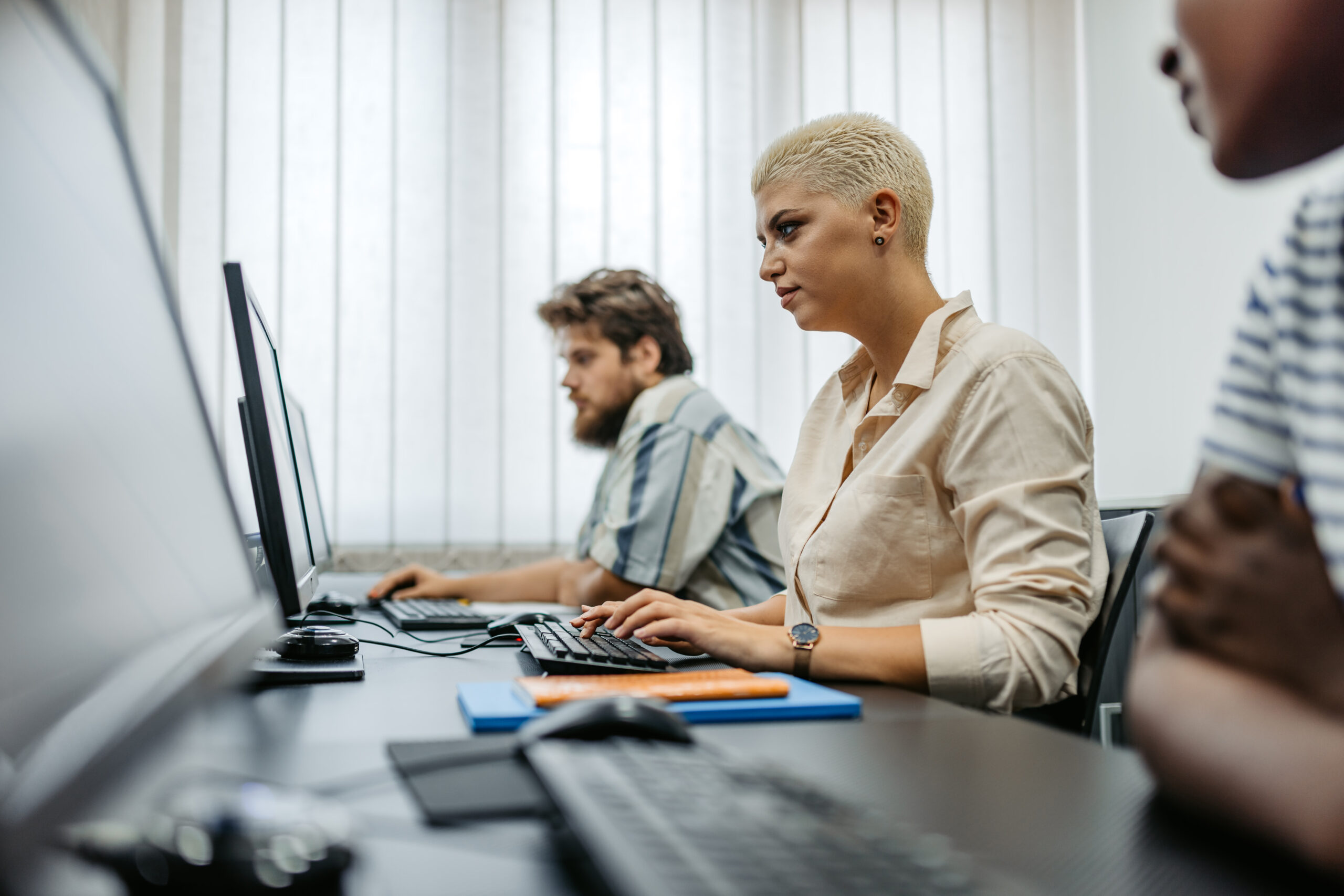 Students sitting in a programing class and learning.