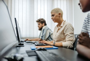 Students sitting in a programing class and learning.