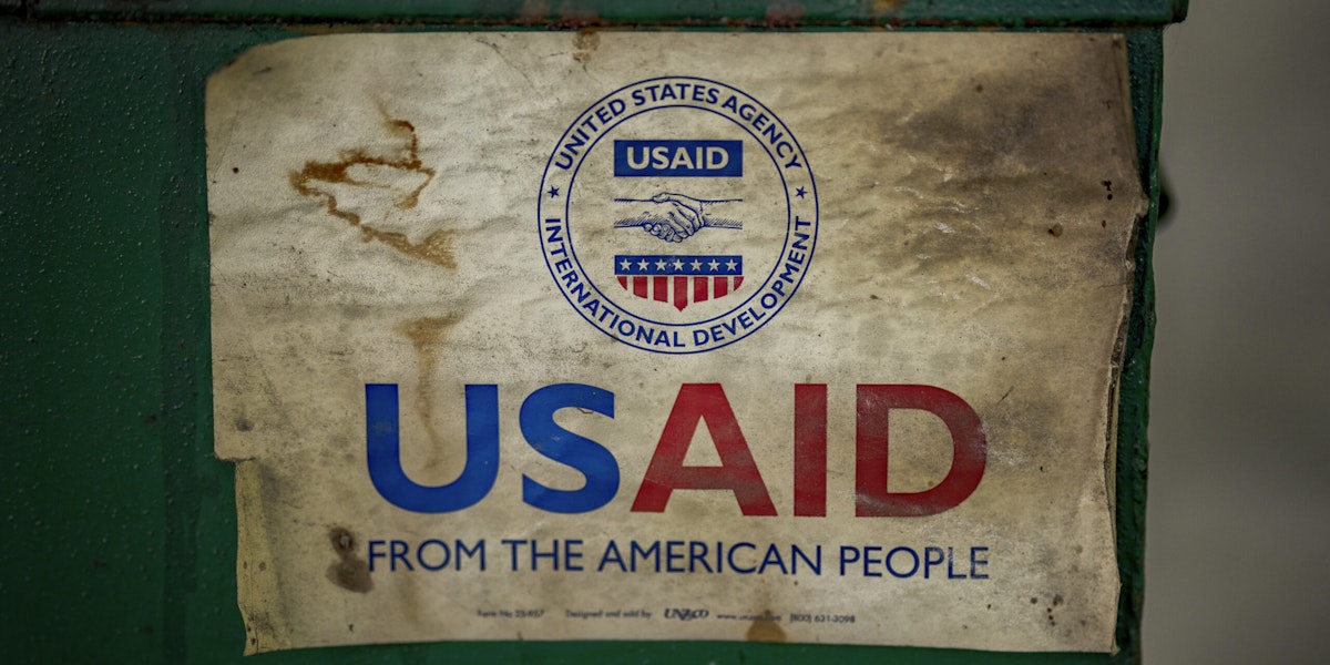 MANILA, PHILIPPINES - MARCH 10: The USAID logo is seen on a machine that processes recycled plastic into construction blocks at the Pasig Eco Hub, a project impacted by the Trump administration's freeze on foreign aid, on March 10, 2025 in Pasig, Metro Manila, Philippines. The recent suspension of USAID funding by the Trump administration has resulted in the loss of at least $69.7 million (approximately PHP 4.06 billion) in aid programs across the Philippines, affecting 39 ongoing projects spanning environmental conservation, health initiatives, disaster response, and education—some of which were set to continue until 2029. Among the impacted projects is the Pasig Eco Hub, a USAID-funded waste management facility, which shut down due to financial constraints, with USAID funding cuts further disrupting its recycling and sustainability programs. (Photo by Ezra Acayan/Getty Images)