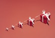 A group of christmas gifts laid on a colorful background. Grows from a small to a large gift.