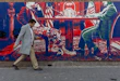 TEHRAN, IRAN - FEBRUARY 1: A man walks past a mural painted on the outer walls of the former US embassy in Tehran, colloquially-referred to as the Spy Den, on February 1, 2026. Iranian Supreme Leader Ayatollah Ali Khamenei today warned of ‘regional war’ if the United States should attack Iran following heavy military deployments by Washington in the Gulf. (Photo by Majid Saeedi/Getty Images)