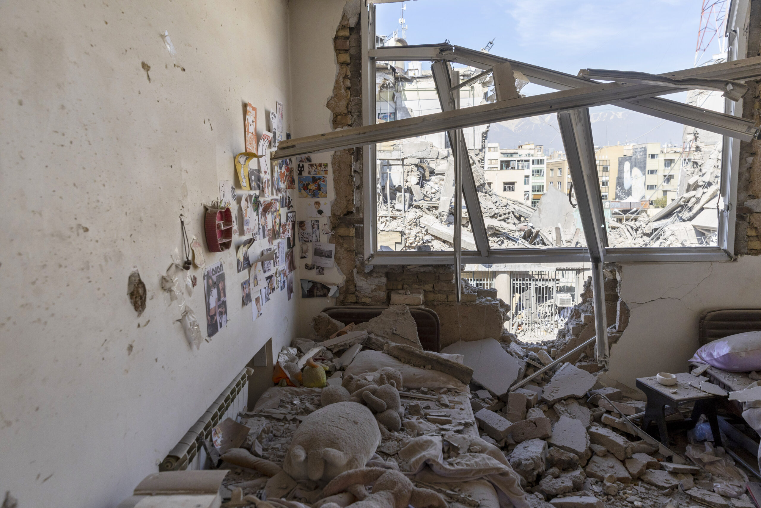 Caption: A bedroom in a damaged residential building, struck during the U.S.–Israeli military campaign, as seen on March 4, 2026, in Tehran, Iran. Source: Majid Saeedi/Getty Images