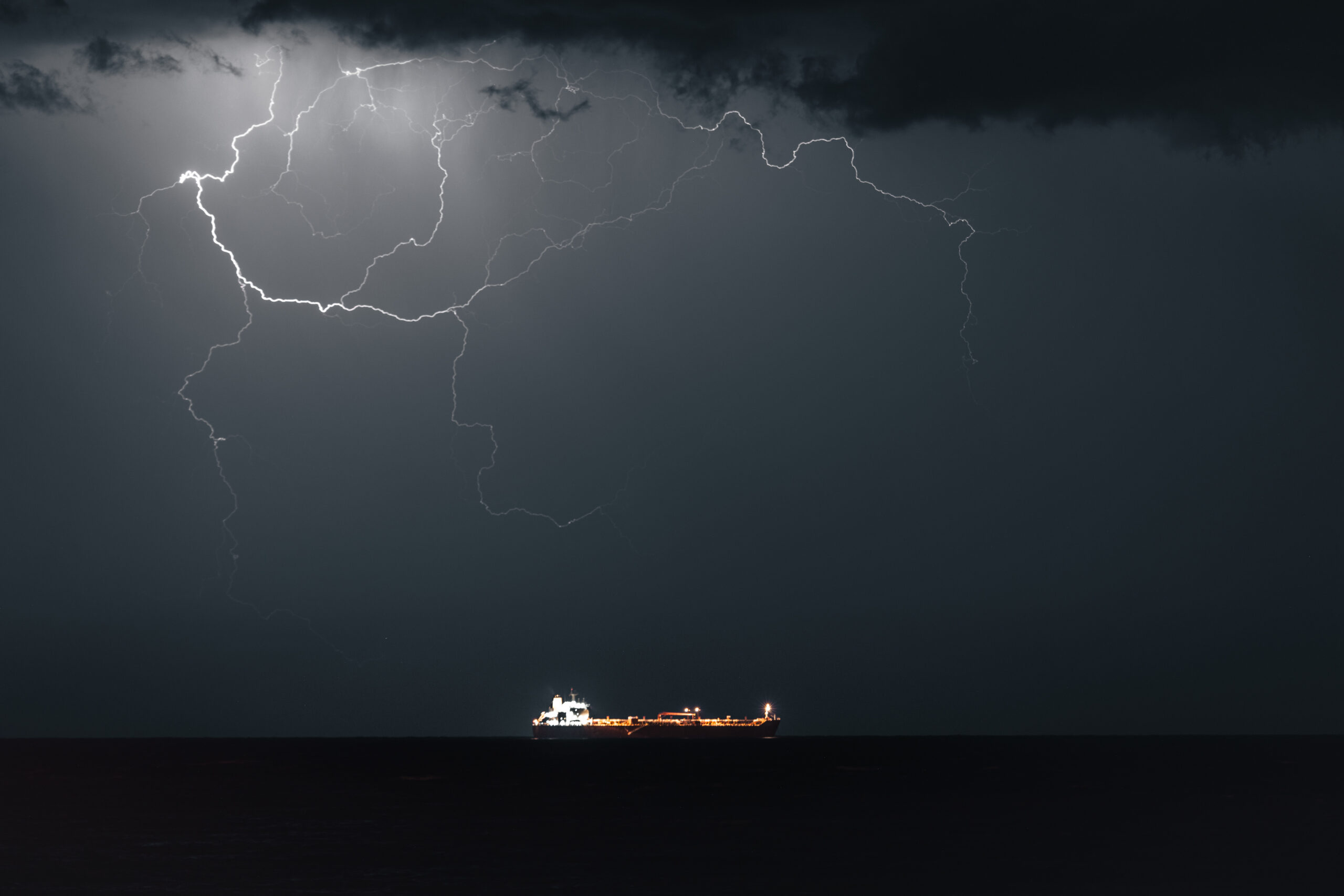 MUSCAT, OMAN - MARCH 21: Lightning occurs when META 4, an Oil Products Tanker, sails into Muscat Anchorage on March 21, 2026 at Sultan Qaboos Port in Muscat, Oman. President Donald Trump had threatened to attack Iran's energy infrastructure if it did not end its de facto blockade of the Strait of Hormuz by just before midnight GMT of March 23. A subsequent statement from President Trump said the U.S. and Iran had held 