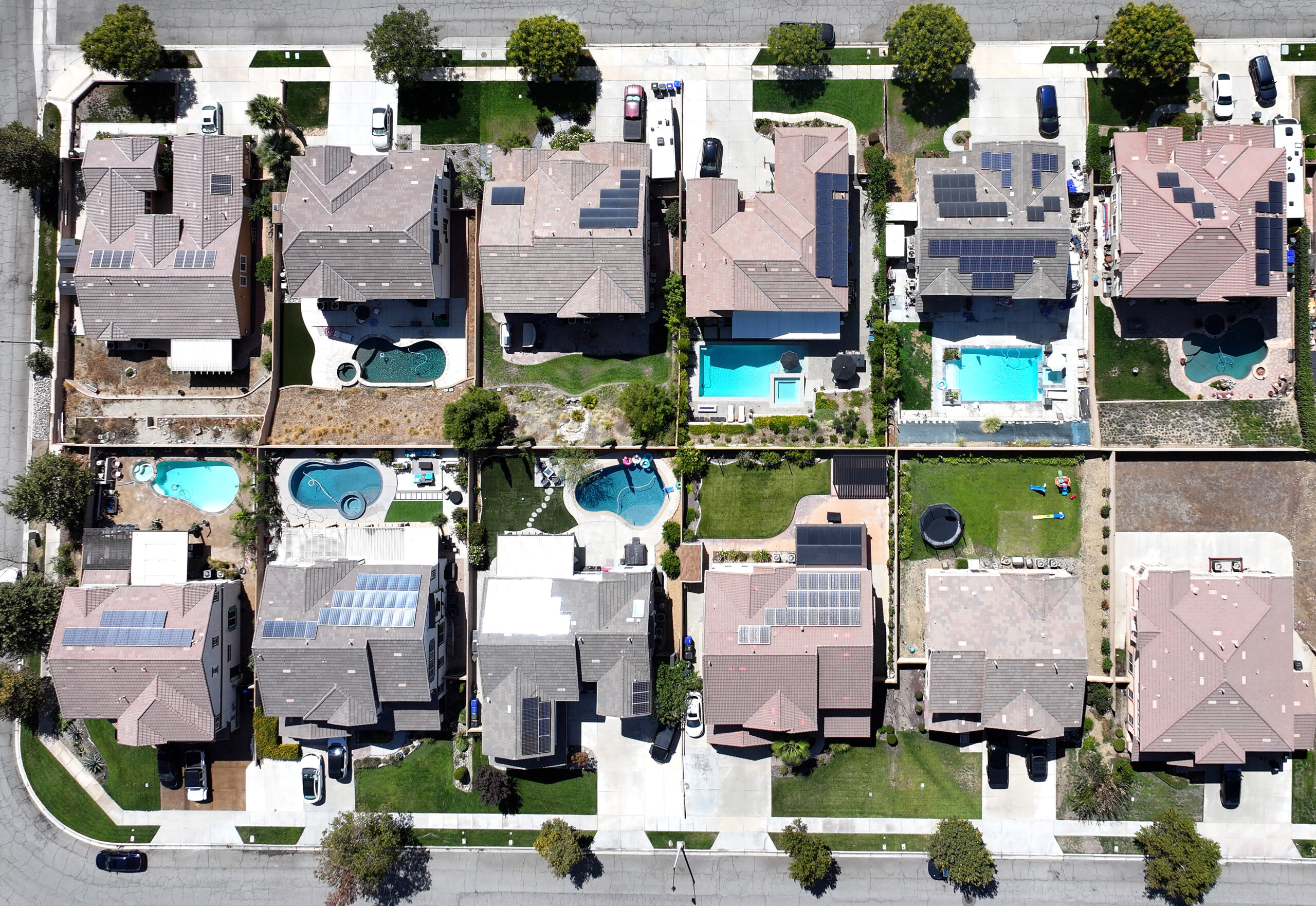 FONTANA, CALIFORNIA - SEPTEMBER 17: An aerial view of residential homes, many with solar panels, on September 17, 2025 in Fontana, California. The 30-year fixed mortgage average rate dropped to 6.13 percent yesterday, the lowest mark since 2022, ahead of today’s Federal Reserve rate cut announcement.  (Photo by Mario Tama/Getty Images)