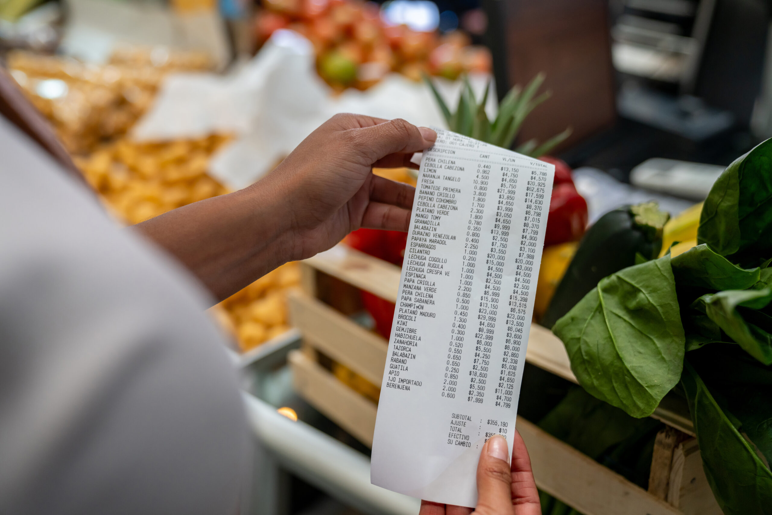 Close-up on a woman shopping at a supermarket and checking her receipt